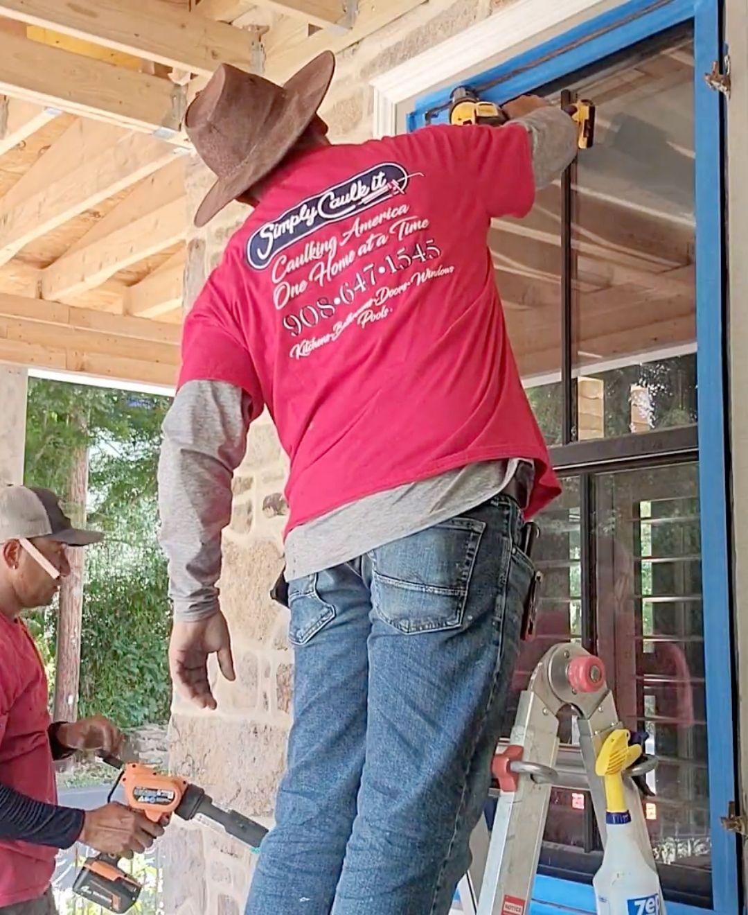 a Simply Caulk It employee caulking a window